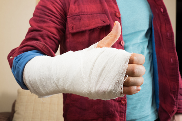 Thumbs Up sign from person with a casted hand