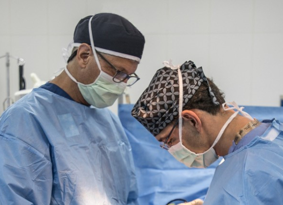 Michael Behr, MD and Peter Symbas, MD perform surgery