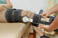 Orthopedic doctor with patient in knee brace