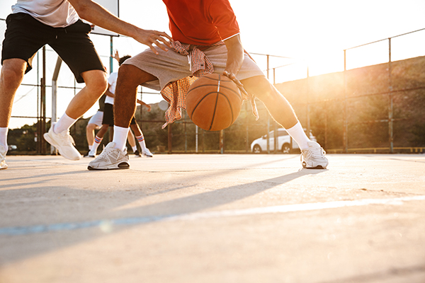 Outdoor Basketball Game Player Dribbling