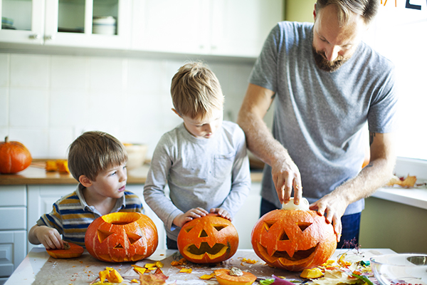 Family carving a pumpkin